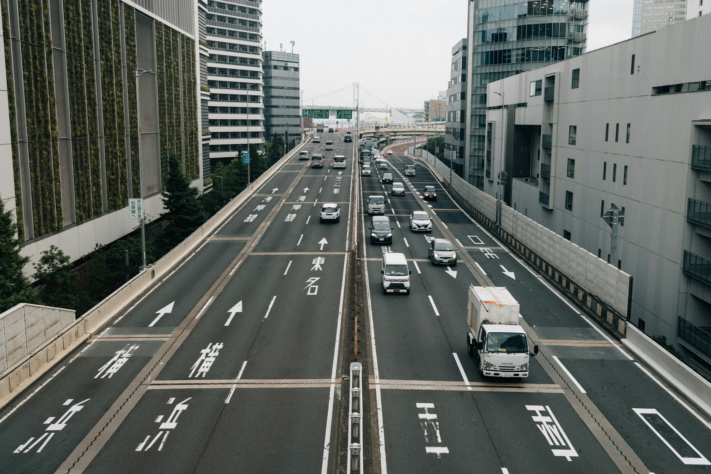 Cars on a multi-lane highway between city buildings in Japan
