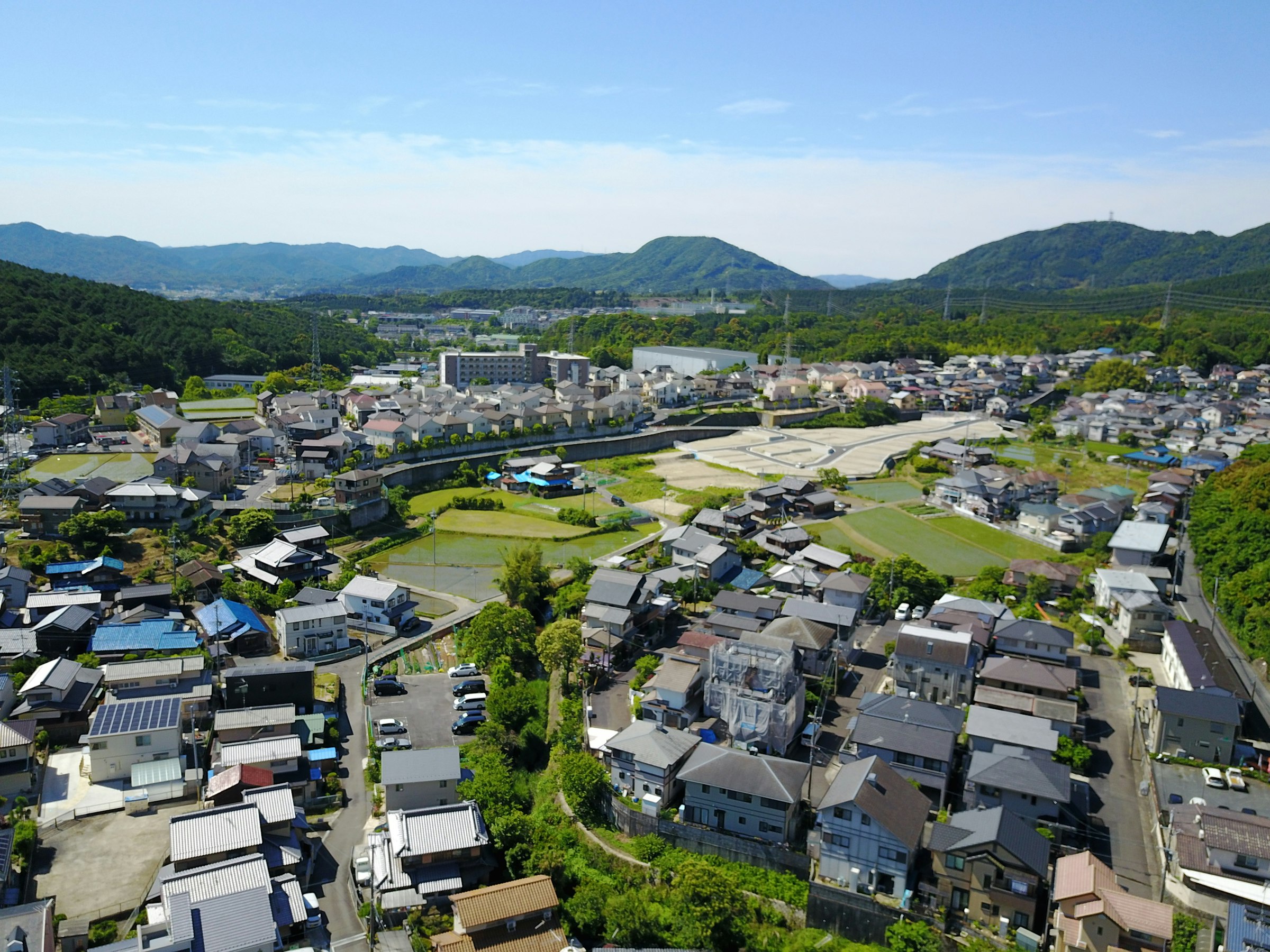 Aerial view of Otsu with forested mountains behind the city