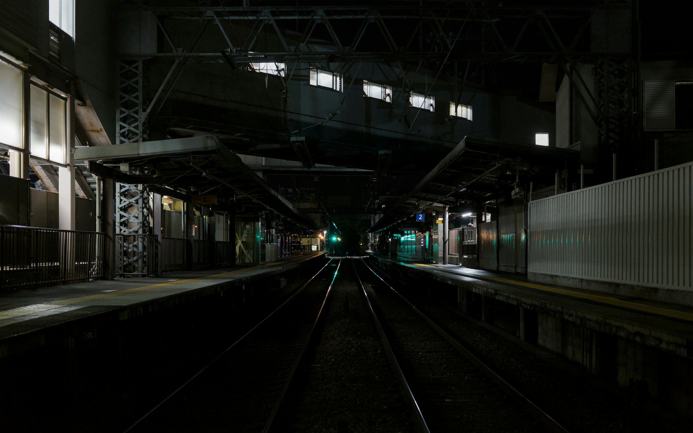 Empty station platforms and tracks at night in Kyoto